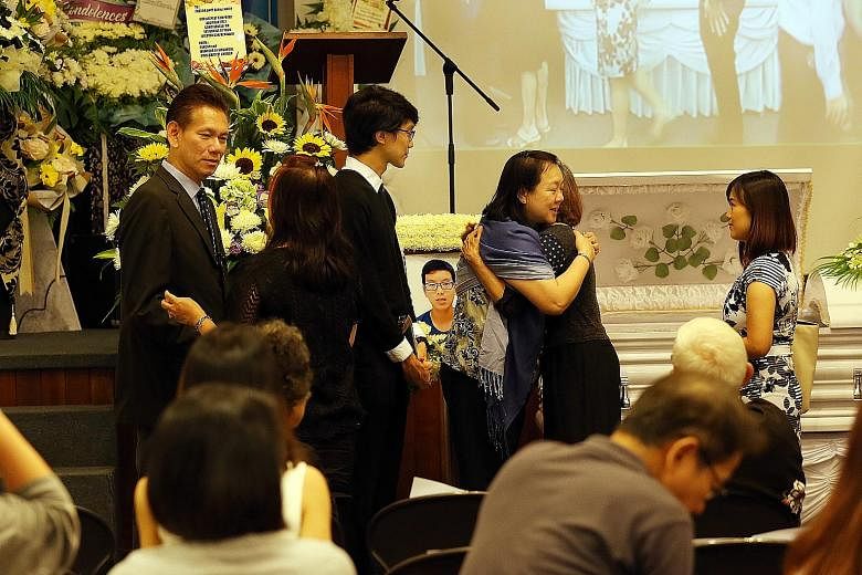 (From left) Benjamin's father, Pastor Davy Sim, brother and mother at the 16-year-old's wake at the Singapore Bible Baptist Church. More than 300 people turned up yesterday to pay their respects.