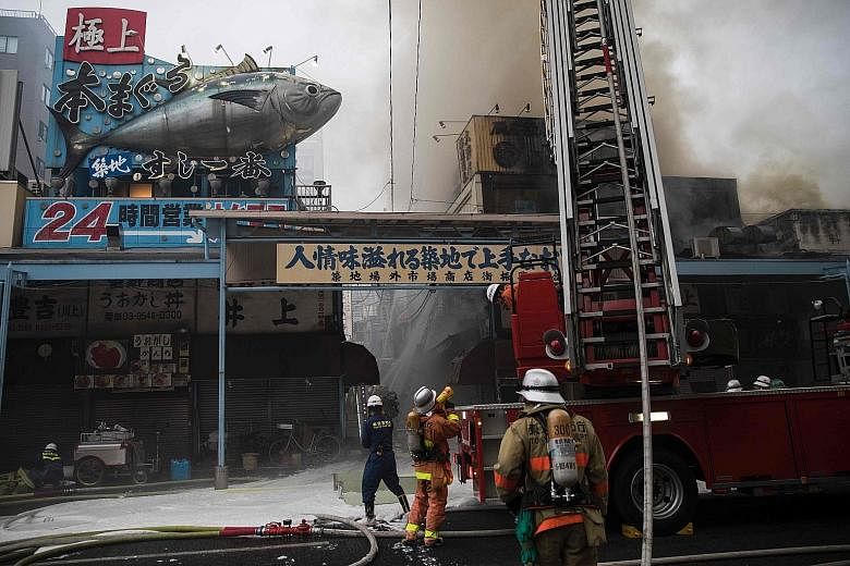 Firefighters trying to extinguish the fire at Tokyo's famous Tsukiji fish market on Thursday. A Tokyo Fire Department spokesman said the cause is still under investigation.