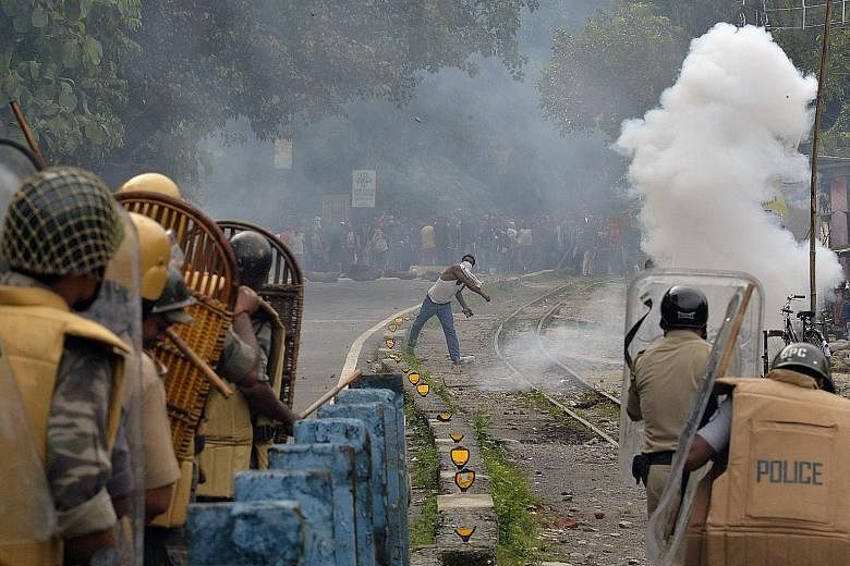 A supporter of a separate "Gorkhaland" within West Bengal hurling objects at the police during a strike at Sukna village in the Darjeeling district, near Siliguri, on July 29. Tourism has also been badly hit by the dispute in which the main Gorkha gr