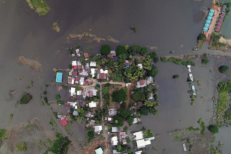 A flooded area in Sakon Nakhon province, north-east Thailand, yesterday. Ten of the 77 provinces have been inundated in the middle of the annual rainy season, causing damage estimated at US$300 million (S$407 million).