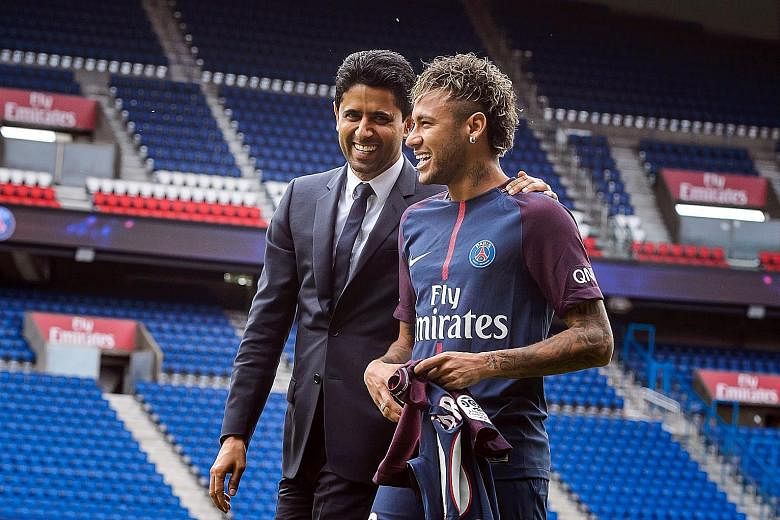 Paris-Saint Germain's chairman and chief executive Nasser Al-Khelaifi and Brazilian striker Neymar are all smiles after a press conference at the Parc des Princes stadium yesterday.