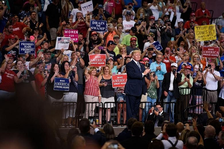 Mr Donald Trump on stage after speaking at a rally on Thursday in Huntington, West Virginia - the heartland of his support. The President lashed out at the Democrats before a crowd of nearly 10,000.