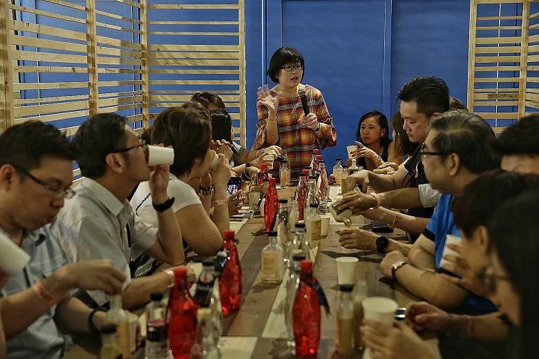 Above: Straits Times Life editor and veteran food writer Tan Hsueh Yun hosting dining session Posh Nosh: An Omakase Experience for a sold-out crowd of 24 diners yesterday at this year's Coffee Festival. Below: The Coffee Academics' coffee in a cone i