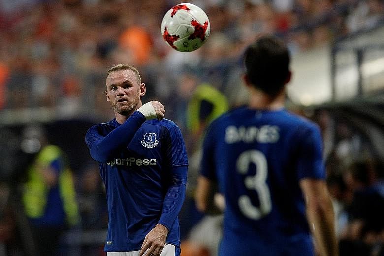 Wayne Rooney (far left, with Leighton Baines) during Thursday's return leg of the Europa League third qualifying round in Slovakia. The Toffees beat Ruzomberok 1-0 in both legs.
