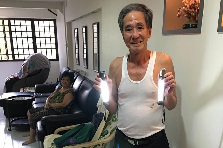 Mr Lim Cher Hian and his wife, Madam Leow Lee Keng, in their flat at Block 14A, Lorong 7, Toa Payoh. Their flat's electricity supply was cut off for a day in June, so he bought two LED torchlights as a standby.