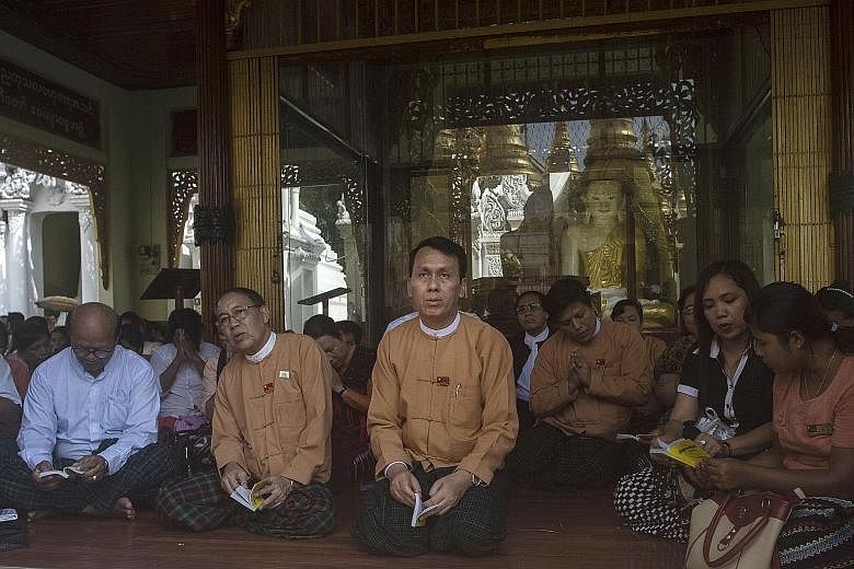 This photo, taken on May 18, shows Yangon Chief Minister Phyo Min Thein (centre) attending prayers for the recovery of the National League for Democracy party's patron Tin Oo at the Shwedagon Pagoda in Yangon. There was no public tender or debate in 