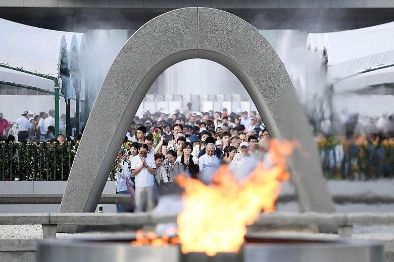 People praying at Hiroshima's Memorial Cenotaph yesterday for the victims of the 1945 atomic bombing. Japan is the only country to have suffered atomic attacks, which claimed 140,000 lives in Hiroshima.