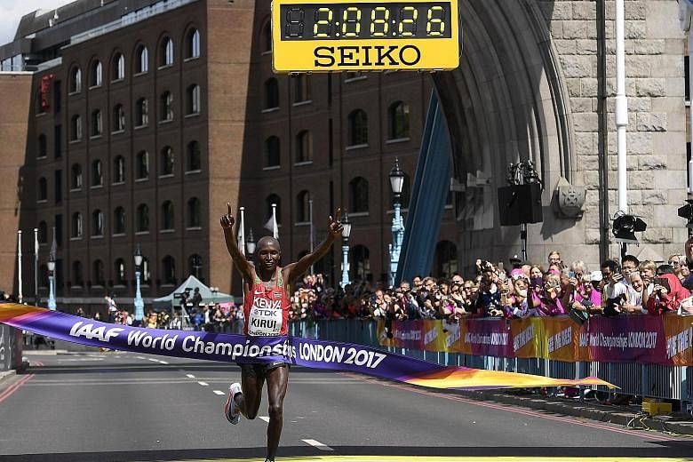 Geoffrey Kirui of Kenya celebrates after winning the marathon at the athletics World Championships in London yesterday. Ethiopia's Tamirat Tola finished second and Tanzania's Alphonce Simbu took the bronze.