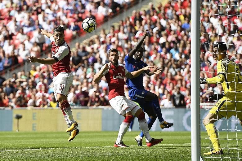 Sead Kolasinac (far left) heads in a late equaliser on his Arsenal debut. The Bosnian defender replaced the injured Per Mertesacker in the first half.