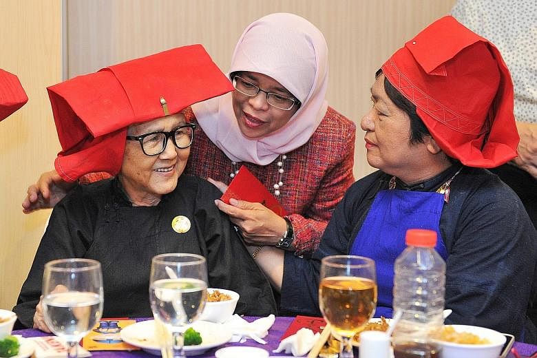 Left: Madam Halimah Yacob, seen here cooking in the kitchen of her HDB flat, is known for being down to earth and close to the ground. She said that living in the heartland gave her a keen sense of what bothered people and the daily frustrations they