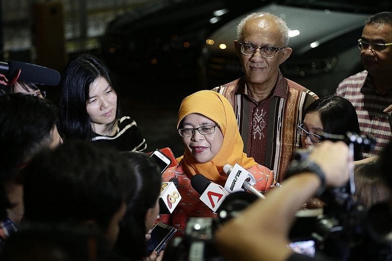 Madam Halimah Yacob, accompanied by her husband Mohammed Abdullah Alhabshee, speaking to the media after announcing her decision to run for president at the Marsiling National Day dinner yesterday.