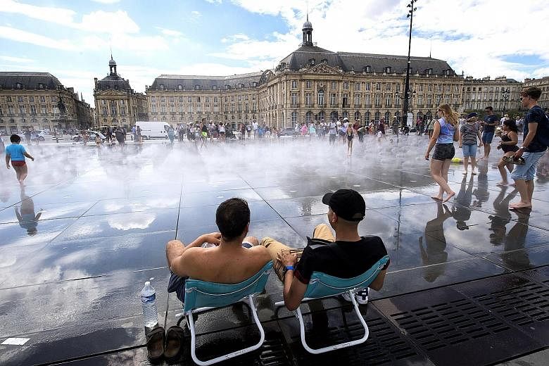 People refreshing themselves in the Water Mirror fountain in Bordeaux, France, last Friday. There has yet to be any sign of visitors to southern Europe being deterred by the heatwave.
