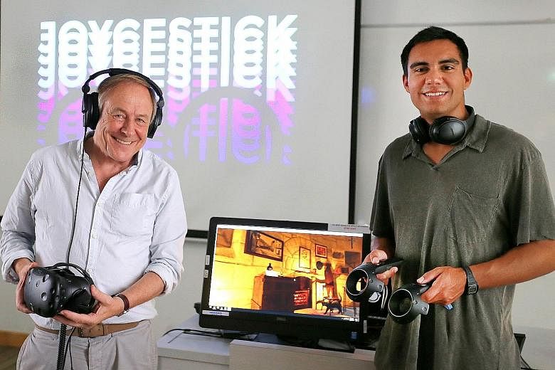 Professor Joseph Nugent of Boston College (left) and Mr Ryan Reede, a computer science major at the university, demonstrating Joycestick, a 3D virtual reality game that takes one inside Irish writer James Joyce'snovel Ulysses.