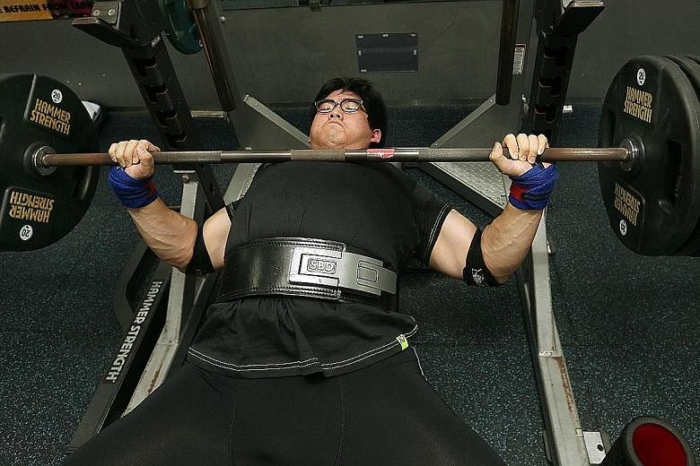 Medical officer Benjamin Soh doing a 190kg bench press, one of the three types of lifts in powerlifting. Strength training helps to improve one’s bone health, prevent falls and even reduce the risk of diabetes. 