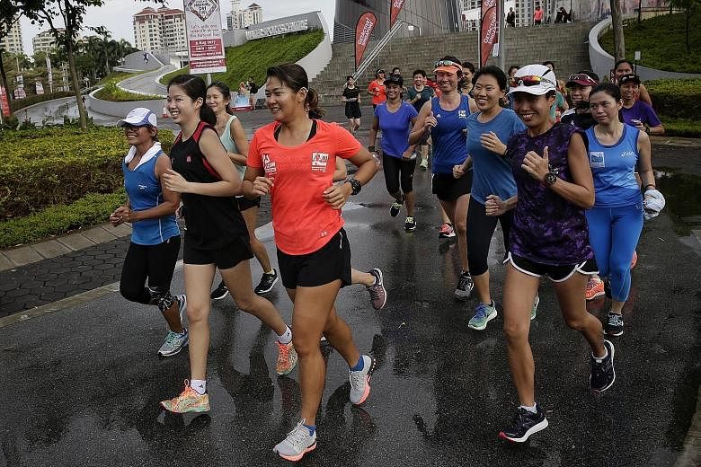 Rockrunners founder Cheryl Tay (in orange) leading the pack in a 3km run during the Women's Squad Activation launch at the Singapore Sports Hub on Sunday.
