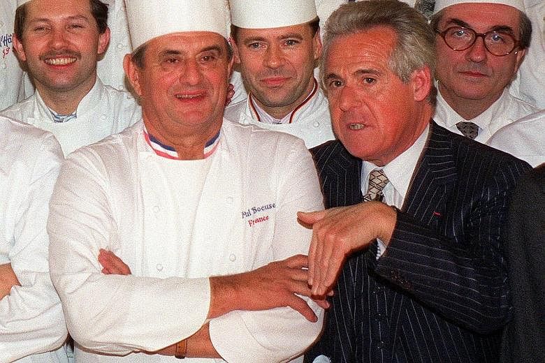 French gastronomy critic Christian Millau (in suit) with French chef Paul Bocuse (front, left) and other famous French chefs in Paris in 1989.