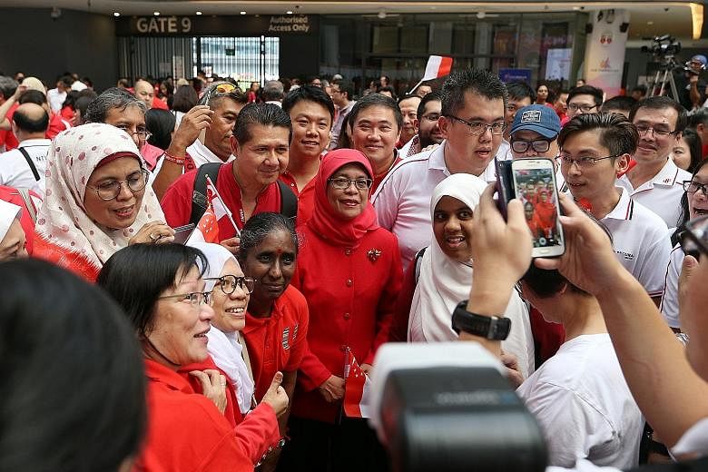 Madam Halimah Yacob with union leaders at the NTUC National Day Observance Ceremony at Our Tampines Hub yesterday. It was her first appearance at a union event after she announced her intention to contest in the upcoming presidential election.