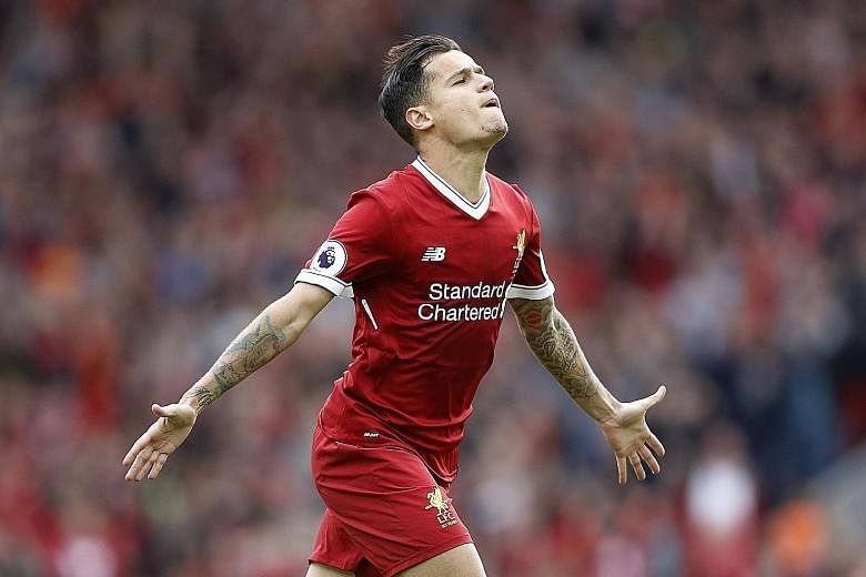 Philippe Coutinho celebrating one of his 13 league goals last season. His uncertain future amid interest from Barcelona has added to the unease surrounding Liverpool's transfer business this summer.