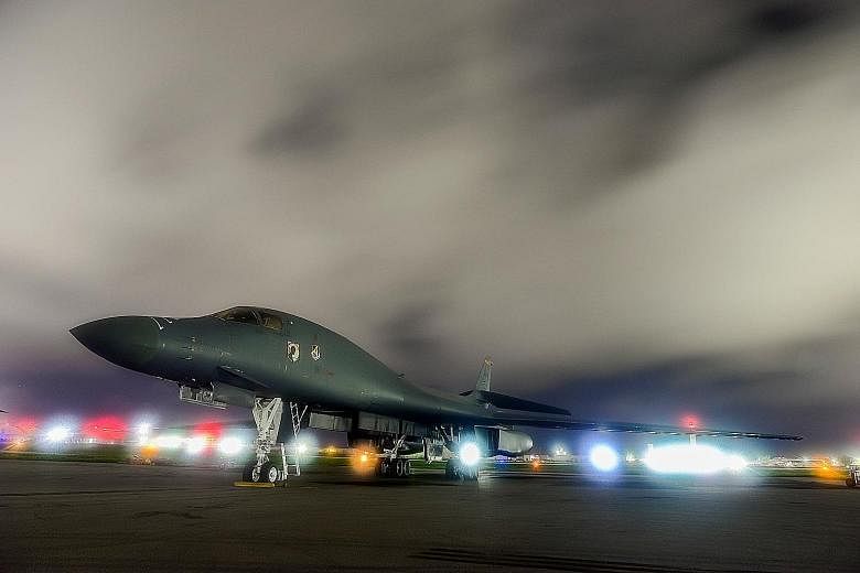 A US Air Force bomber on the runway at Anderson Air Force Base in Guam last month. North Korea's military has threatened to launch missiles that would create "enveloping fire" around Guam, in order to contain major US military bases there.