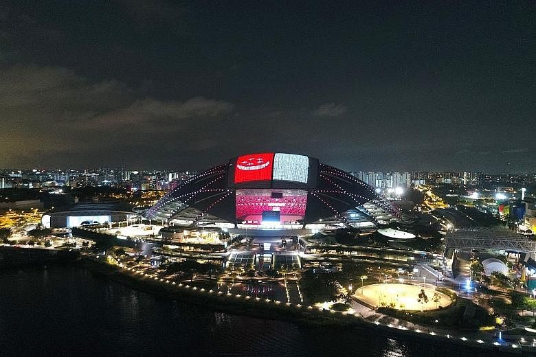 The National Stadium's domed roof was lit up with the Republic's flag as part of the Singapore Sports Hub's National Day celebrations yesterday. Close to 12,000 visitors attended the Sports Hub National Day Fiesta and participated in various sports, 