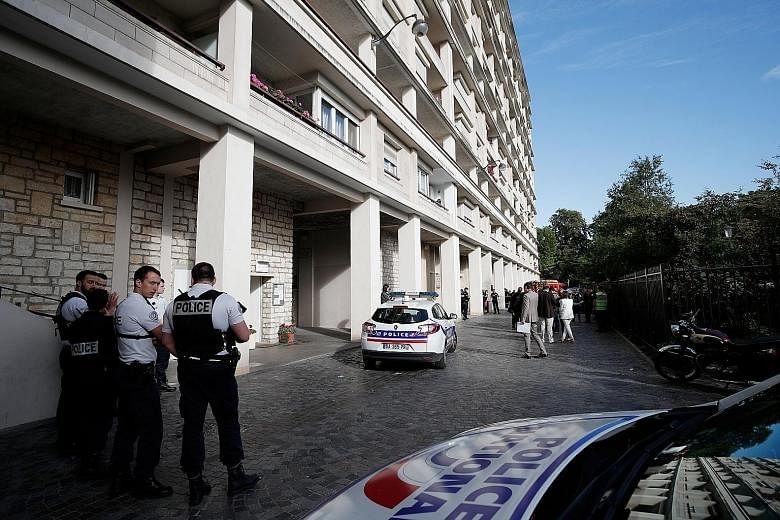 Police cordoning off the area (above) where a car had slammed into soldiers on patrol on a quiet street in the Paris suburb of Levallois-Perret (below). Six of the soldiers were injured and taken to hospital.
