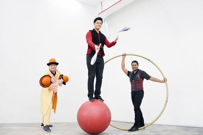 Mr Edward Chua (far left), who specialises in hat juggling, with Mr Benjamin Teo (centre), whose forte is juggling, and Mr Firdaus Ayoob Piperdy, the roue cyr (cyr wheel) specialist. Circus In Motion founder Jay Che, under whose guidance Mr Teo, Mr C