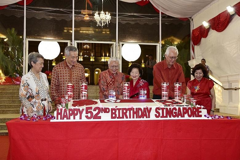 President Tony Tan Keng Yam and Mrs Mary Tan cutting a cake to mark Singapore's 52nd birthday along with Prime Minister Lee Hsien Loong, Mrs Lee, Emeritus Senior Minister Goh Chok Tong and Mrs Goh at the National Day Reception yesterday. Held at the 