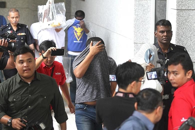 The suspect, who cannot be named to protect the victim, at the Sessions Court in Putrajaya yesterday. He is alleged to have sodomised and raped his 15-year-old daughter more than 200 times in three months.