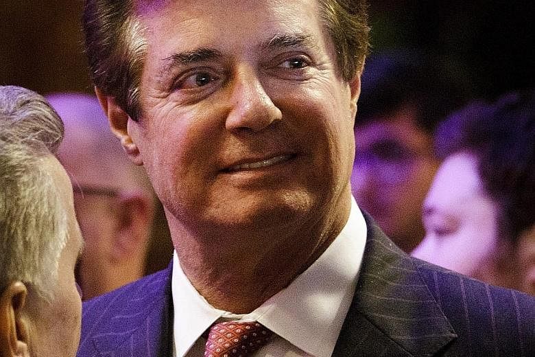 A video camera from a news network on Wednesday recording a building in Alexandria, Virginia, where Mr Paul Manafort (above) owns an apartment. Investigators are said to have executed a search warrant for tax documents and foreign banking records.