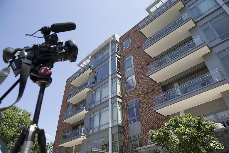 A video camera from a news network on Wednesday recording a building in Alexandria, Virginia, where Mr Paul Manafort (above) owns an apartment. Investigators are said to have executed a search warrant for tax documents and foreign banking records.