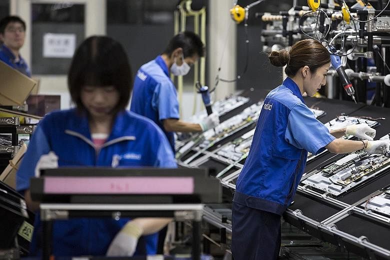 Workers at a Panasonic plant in Tochigi prefecture, Japan. Firms surveyed by the Cabinet Office forecast that core orders would rise 7 per cent in the July-September quarter. A government official said "the third-quarter outlook for manufacturers' or
