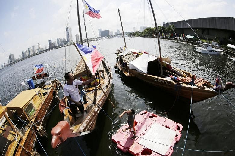 Filipino boats anchored near the venue of the recent Asean Foreign Ministers' Meeting in Manila. While many Asean members seek a legally binding code of conduct to control the behaviour of countries in the South China Sea, the difference between bind