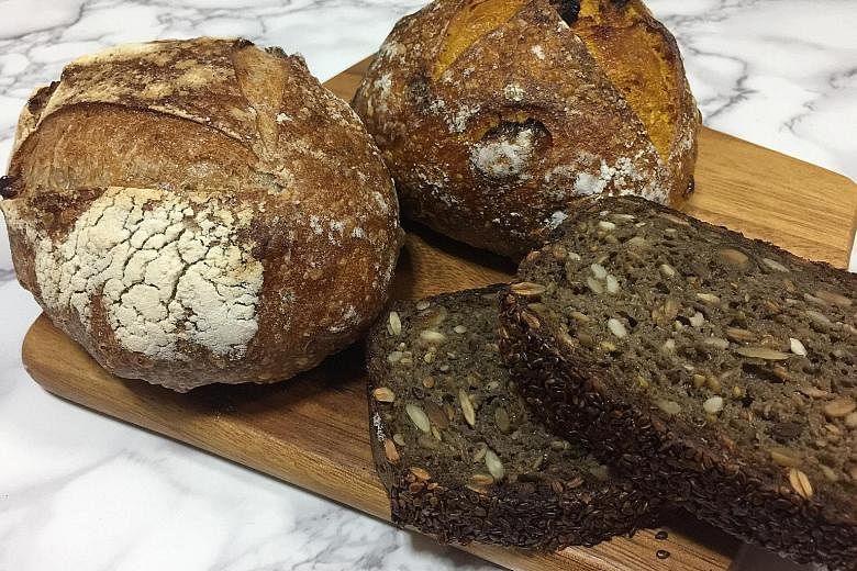 Mr Kneady's sourdough bread offerings include (clockwise from far left) walnut, cranberry turmeric and rugbrod, a Danish-style rye bread loaded with sunflower, pumpkin, flax and sesame seeds.