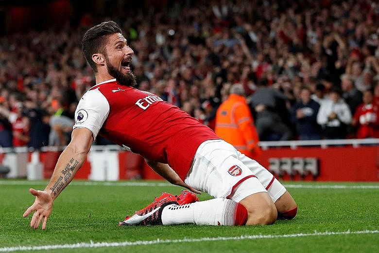 A delighted Olivier Giroud after his 85th-minute header hit the bar and bounced behind the line before Kasper Schmeichel could club it away.