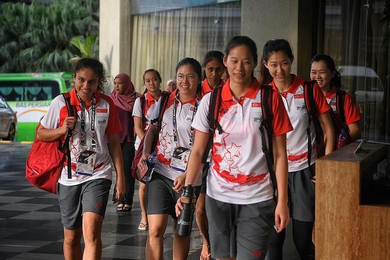 Singapore's netball team arriving at their hotel after a training session yesterday at the Juara Stadium, where they will open their campaign against Brunei tomorrow.