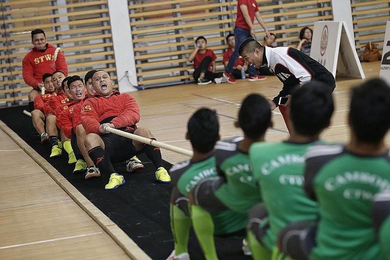 A combined team (in red) from Singapore's Home Team in action against Cambodia during the Asian Tug of War Championships at Republic Polytechnic Sports Hall yesterday. The Singapore team subsequently failed to advance beyond the preliminary round. Th