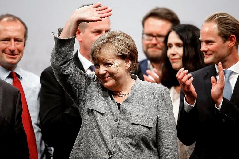 German Chancellor Angela Merkel waving to supporters during an election campaign event in Dortmund yesterday.