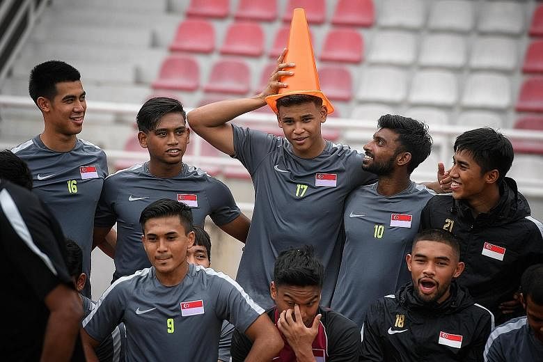 A light-hearted moment as team-mates put a traffic cone on birthday boy Irfan Fandi's head after a training session yesterday. Singapore will meet Myanmar today in the SEA Games.