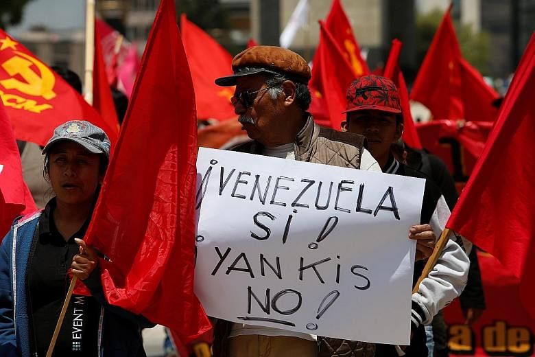 A protester with a placard, which reads "Yes, to Venezuela! No, to Yankees!", in support of President Nicolas Maduro in Mexico City on Saturday. US President Donald Trump said last Friday that military intervention in Venezuela was an option.