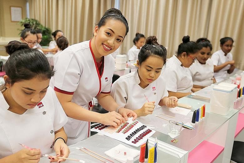 Ms Shuner Villanueva Leong conducting a class on nail art technology at ITE College East. In 2011, Ms Leong, then an ITE student, represented Singapore at the WorldSkills competition in London in the beauty therapy category. She became the first ITE 