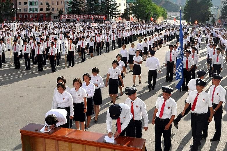 North Korea's working youth and university students queueing up last Thursday to sign petitions to join or rejoin the Korean People's Army, after the United Nations Security Council backed a US-drafted resolution that significantly strengthened sanct