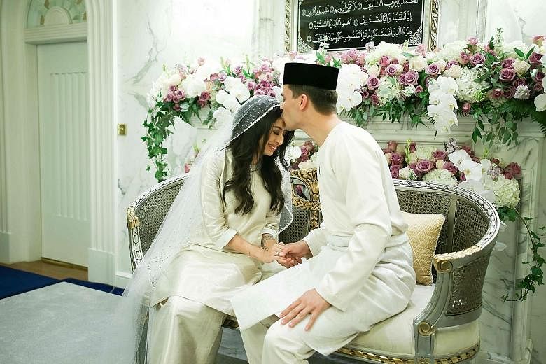 Princess Tunku Tun Aminah Sultan Ibrahim and her groom Dennis Muhammad Abdullah at their wedding at Istana Bukit Serene in Johor Baru yesterday. The bersanding, or sitting-in-state, ceremony was held later yesterday evening at the Grand Palace.