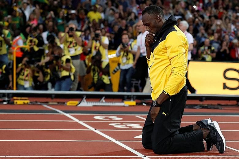 Jamaican great Usain Bolt kneeling down before doing a lap of honour at the World Athletics Championships. He bows out as arguably the greatest track and field athlete of all time.