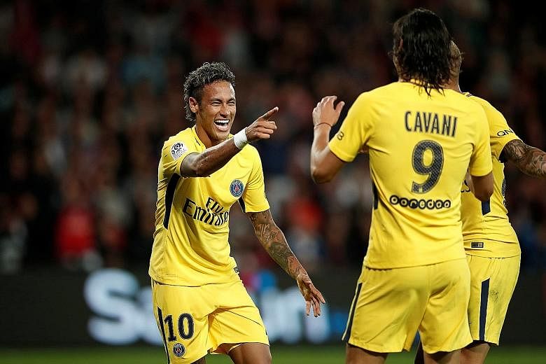 Paris Saint-Germain forward Neymar celebrating his debut goal and his club's third against French Ligue 1 side Guingamp with Uruguayan striker Edinson Cavani. The Brazilian international will be hoping to fire PSG to Champions League glory this seaso