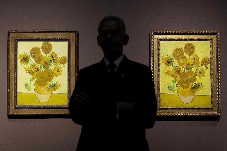 Two versions of Vincent van Gogh's Sunflowers at the National Gallery in London in 2014. The iconic paintings rank among the Dutch master's most famous works.