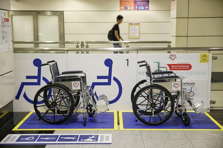 Above: Under another new scheme called Heart Wheels, wheelchairs are available at Outram Park station for elderly commuters and those who are disabled to use on the 210m walkway between the East-West and North-East lines. Left: Mr Francis Tay at Outr