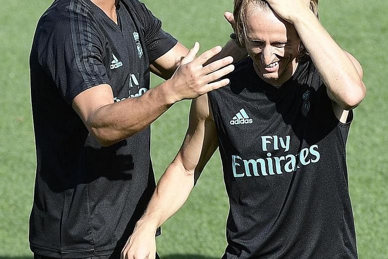 Ronaldo (left) is banned for today's Super Cup second leg match, but Modric will be back for Real Madrid from suspension.