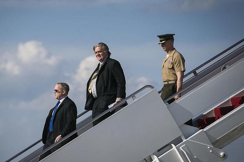 White House chief strategist Steve Bannon (centre), the subject of claims that he is a racist or a sympathiser of white supremacists, is now in a kind of internal exile and has not met President Trump for more than a week.
