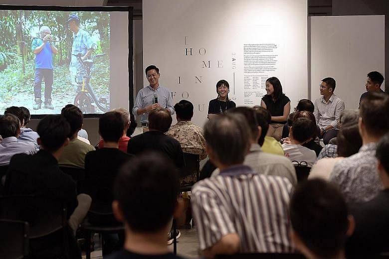 Former ST photojournalist Desmond Lim speaking about his picture spread Durian Hunters at the Home In Focus photo exhibition yesterday. Seated next to him are (from left) Objectifs centre director Emmeline Yong and ST photojournalists Neo Xiaobin, Se