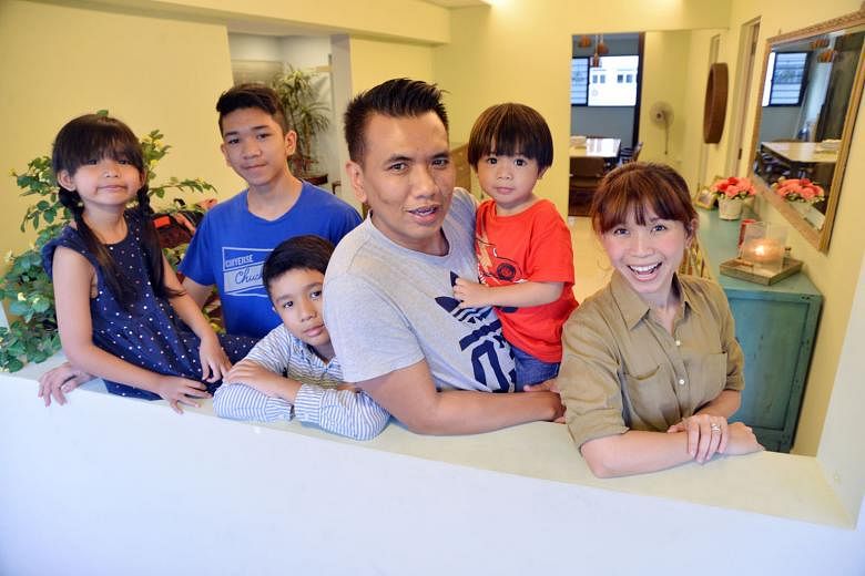 Mr Nurul Hatta Takim, with his wife Hafiza Yahya, and children (from left) Eryna Amelia, eight, Haziq Mateen,14, Ryan Zuhayr, 10, and Aydin Ezra, two. Mr Nurul Hatta and Ms Hafiza hacked down a wall and expanded their master bedroom to create their d